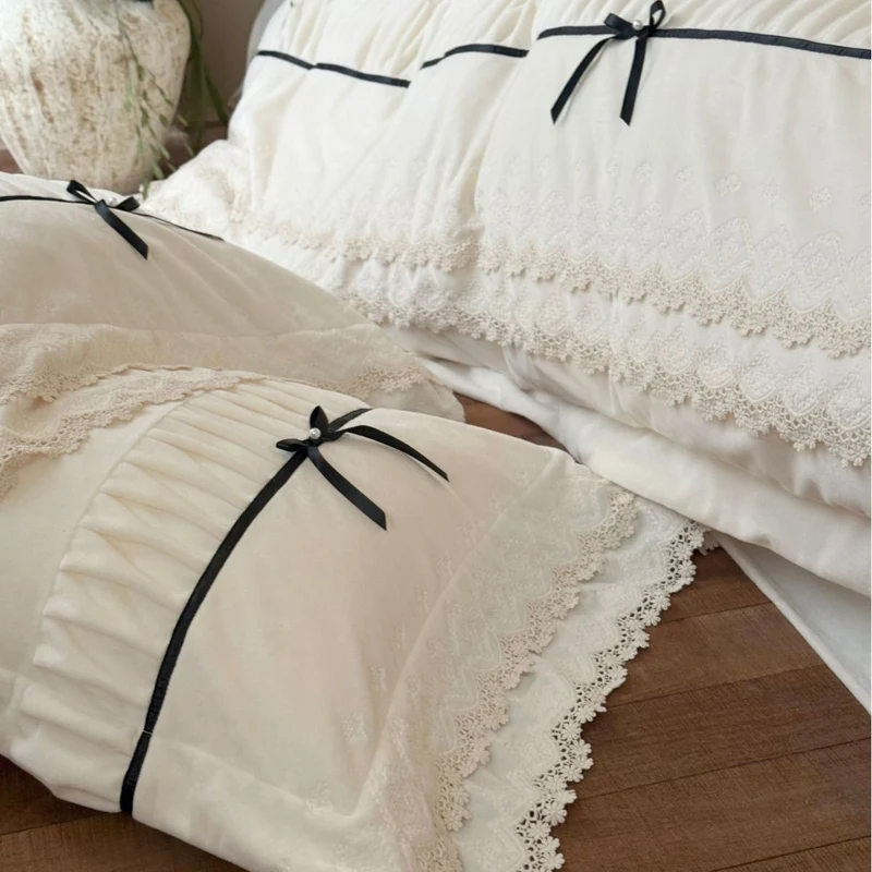 Romantic cotton satin bed linen set with ruffled hem, lace trim and decorative ribbons Stornfield