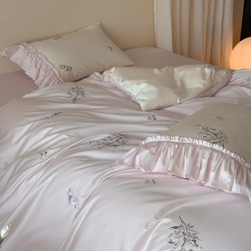 Luxurious satin bedding set with ruffles and delicate floral embroidery Stornfield