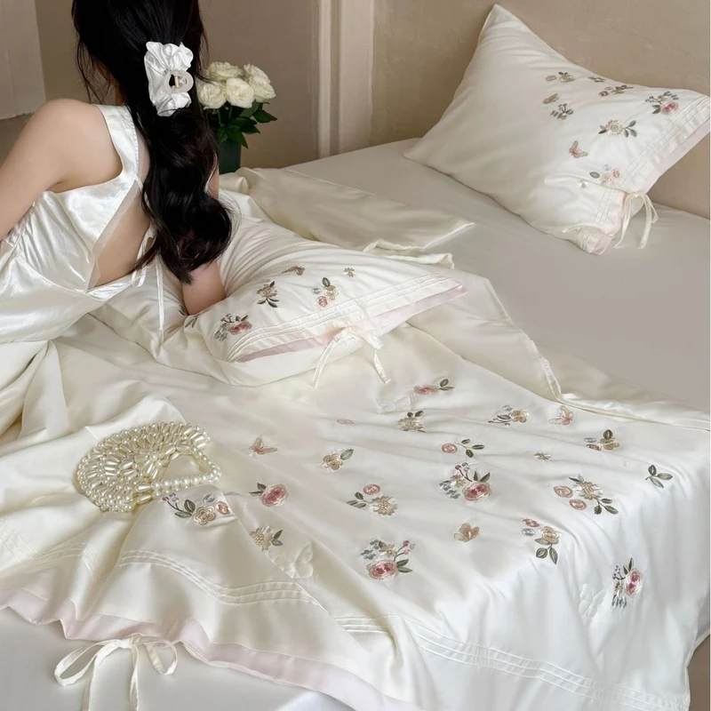 Luxurious satin bedding set with delicate floral embroidery and ribbon closure Stornfield