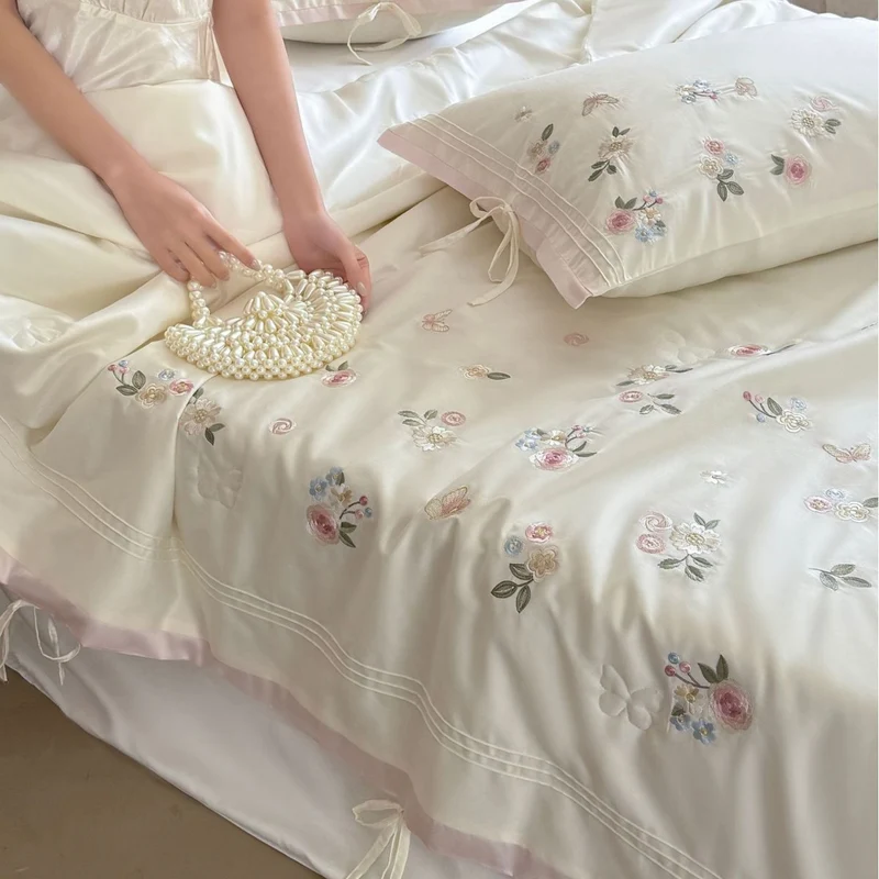 Luxurious satin bedding set with delicate floral embroidery and ribbon closure Stornfield