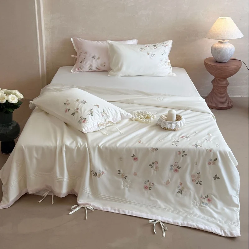Luxurious satin bedding set with delicate floral embroidery and ribbon closure Stornfield