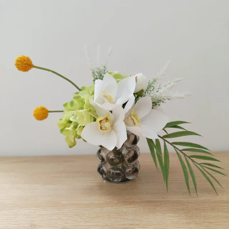 Lifelike Floral Arrangement with Orchids and Greenery