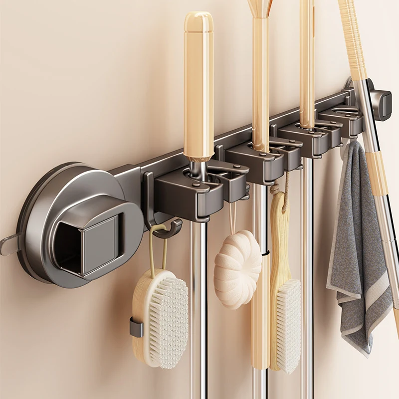 Suction cup holder for brooms and cleaning tools