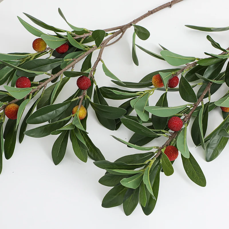 Artificial branch with decorative fruits