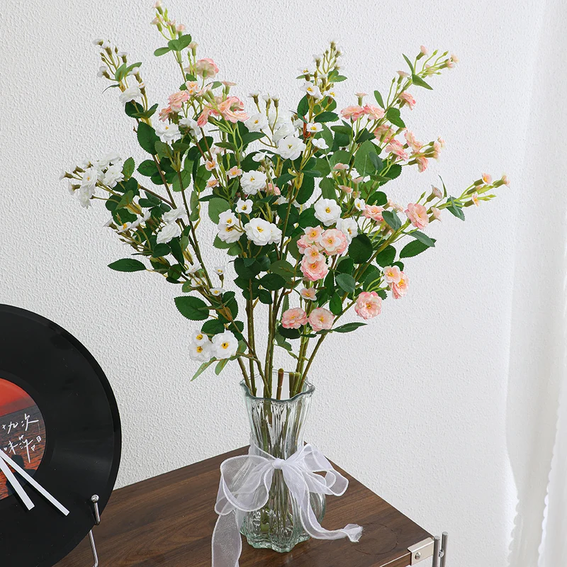 Artificial branch with decorative flowers