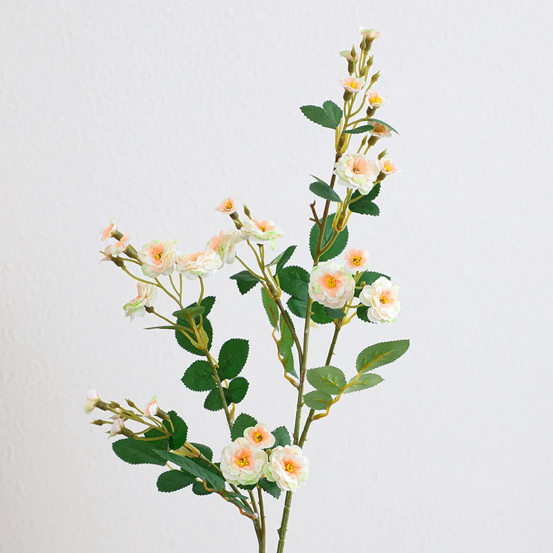 Artificial branch with decorative flowers