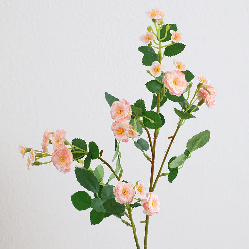 Artificial branch with decorative flowers
