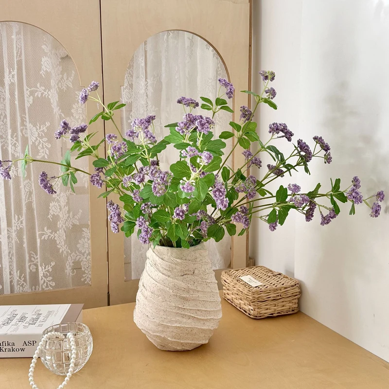 Artificial blossom branch with purple flowers