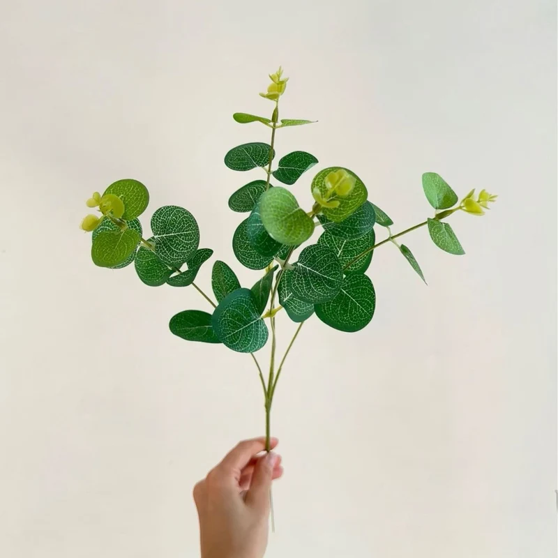 Artificial flowering branch with lifelike leaves and delicate flowers