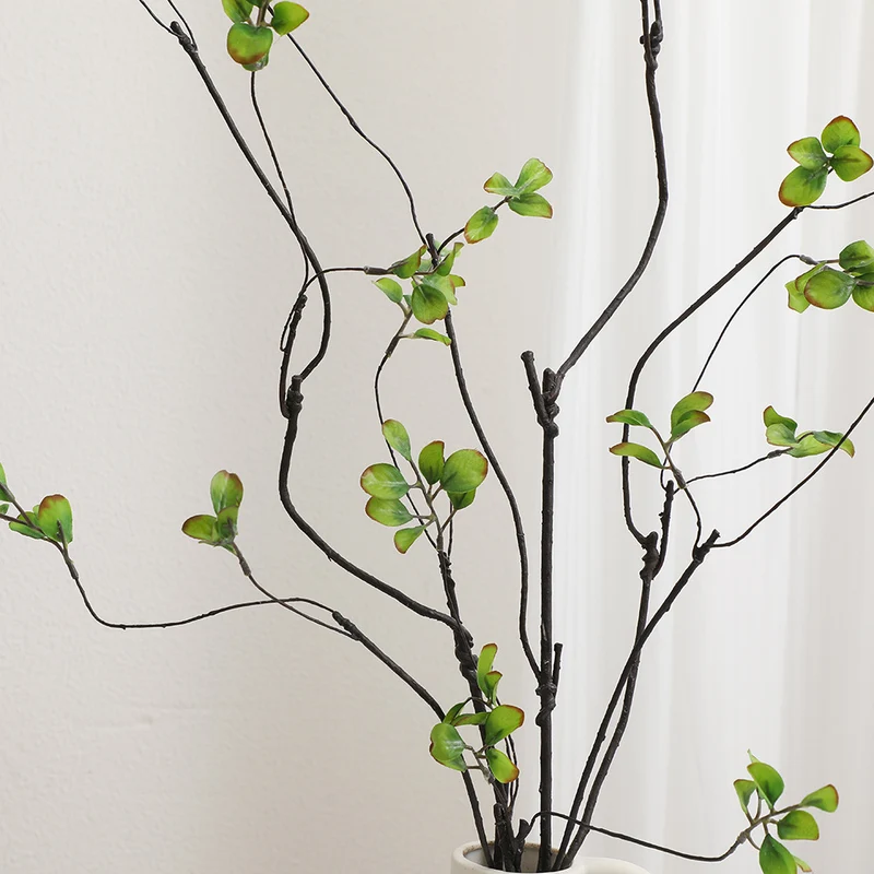 Artificial flower branch with vibrant orange flowers