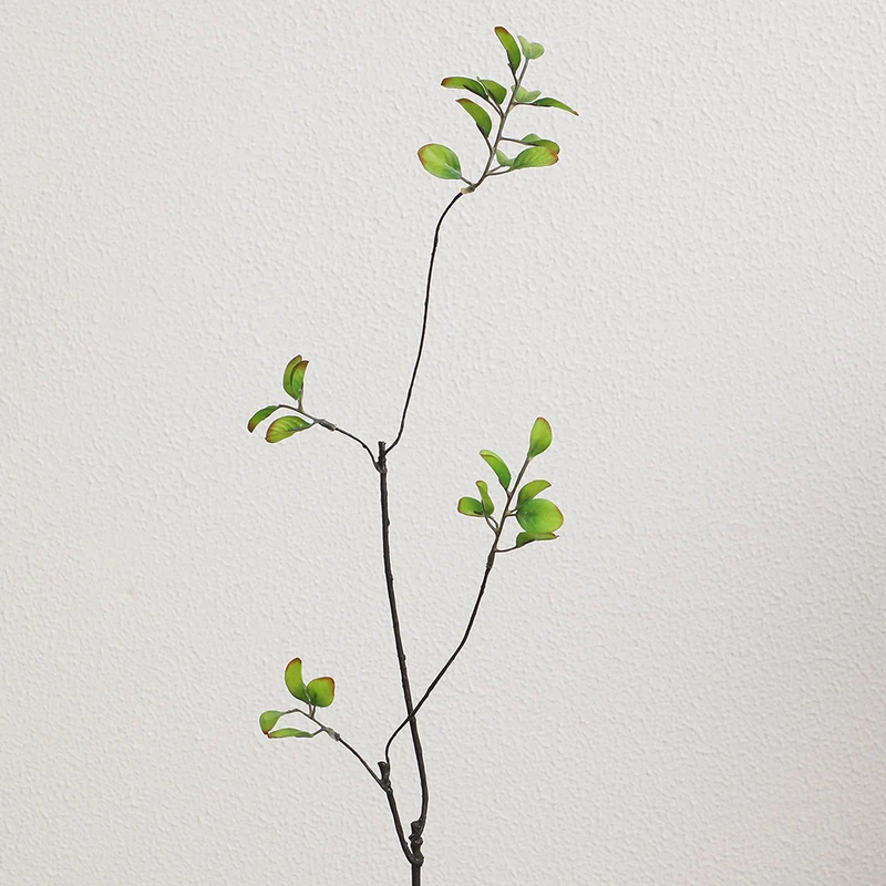 Artificial flower branch with vibrant orange flowers