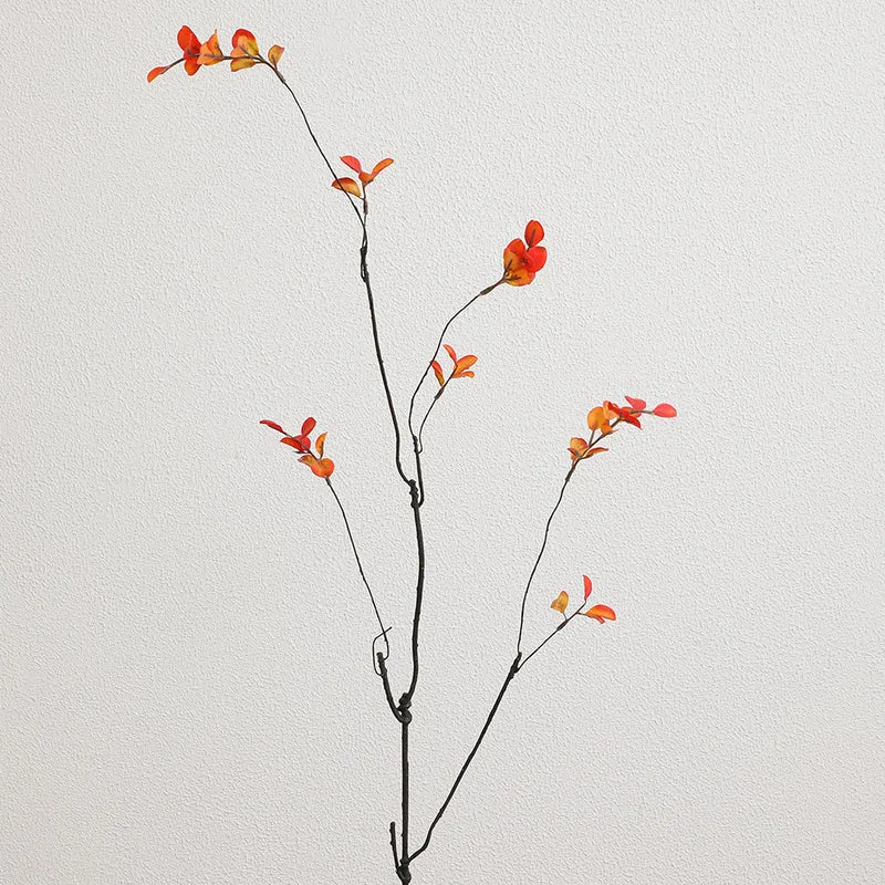 Artificial flower branch with vibrant orange flowers