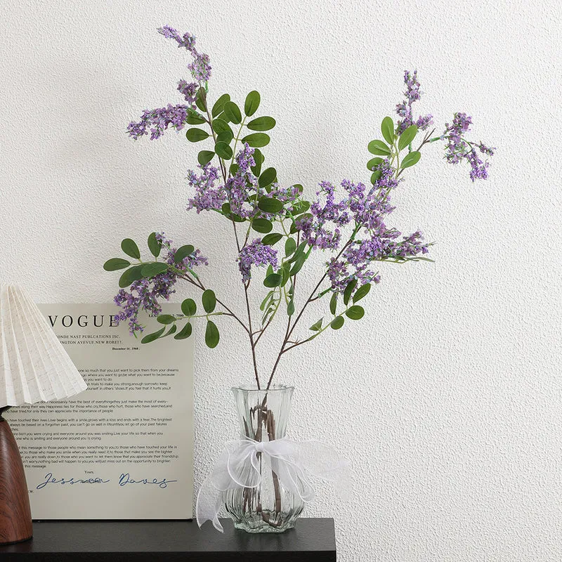 Artificial flower branch with vibrant purple flowers