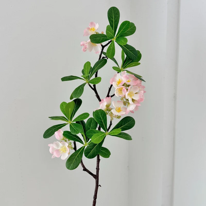 Artificial flower branch with fine pink flowers and vibrant leaves