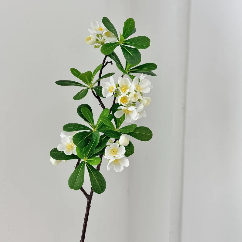 Artificial flower branch with fine pink flowers and vibrant leaves