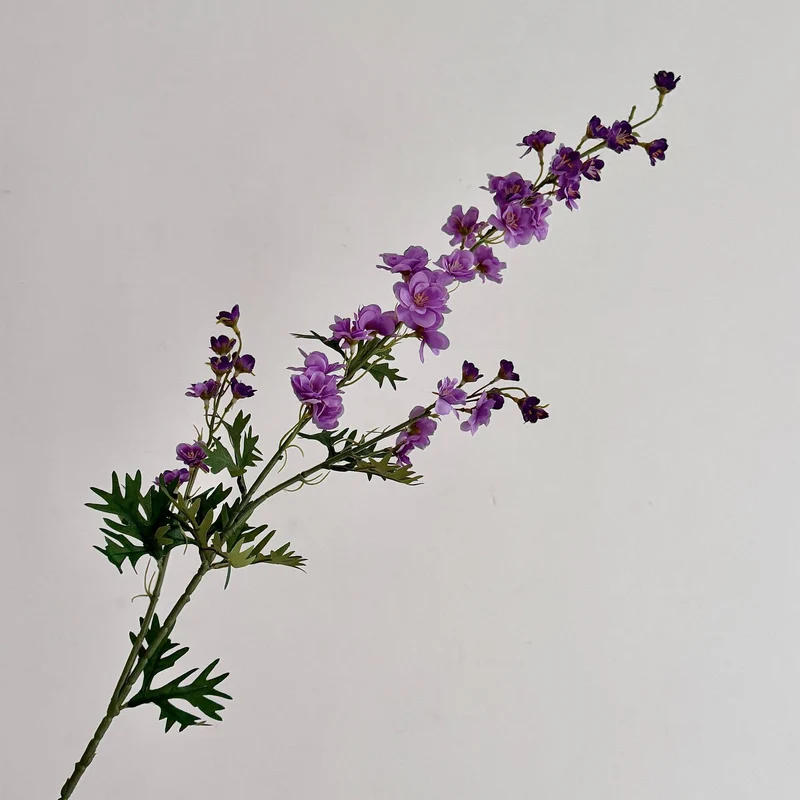 Artificial flower branch with intricately detailed red flowers