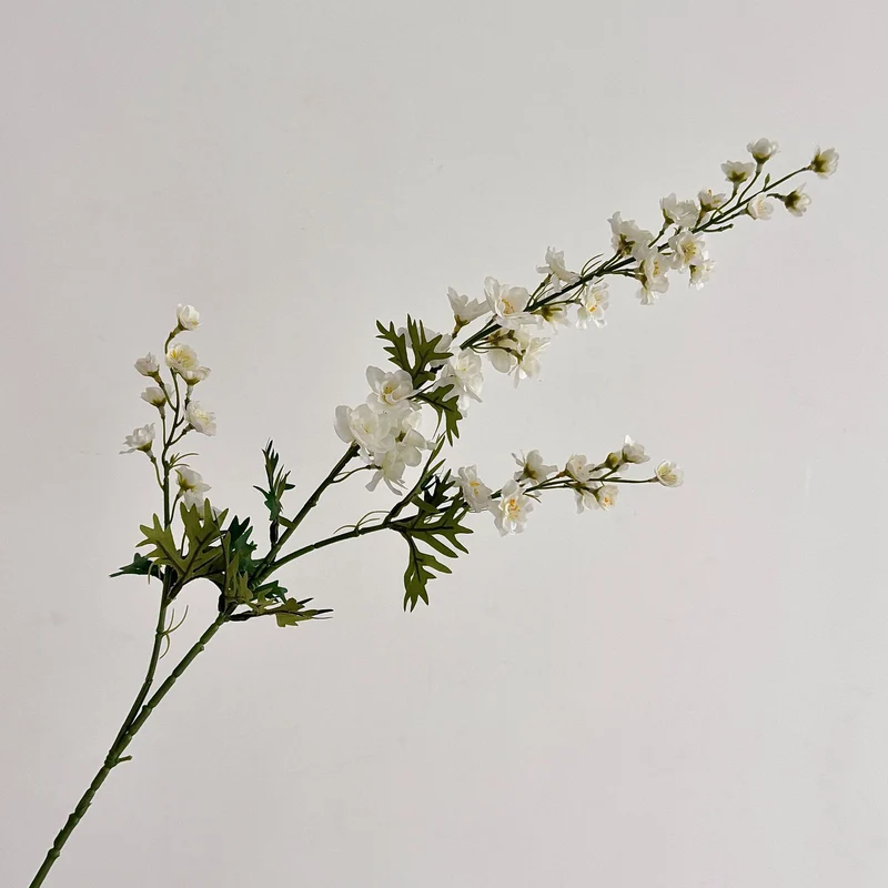 Artificial flower branch with intricately detailed red flowers