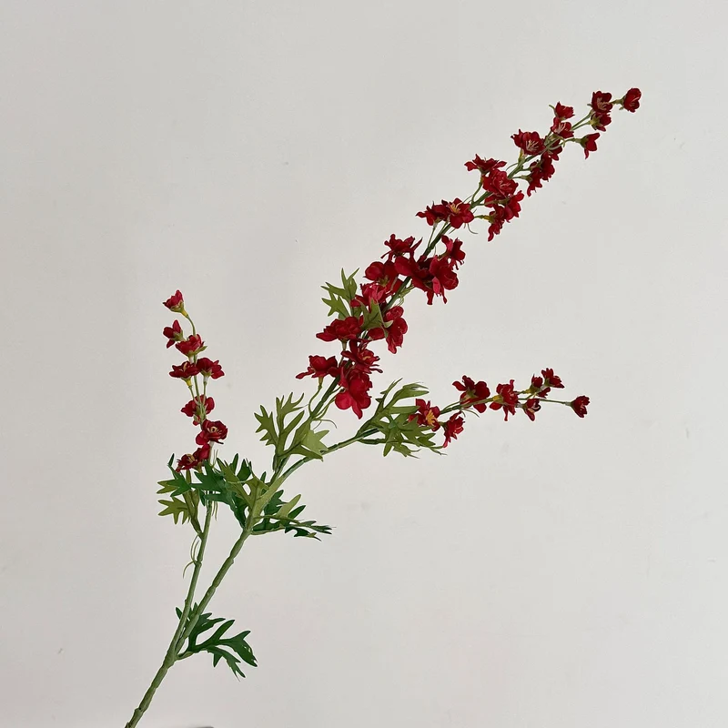 Artificial flower branch with intricately detailed red flowers