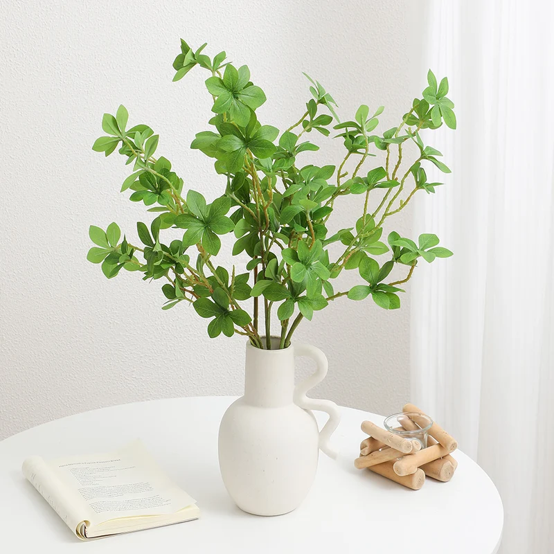 Decorative artificial branch with vibrant leaves