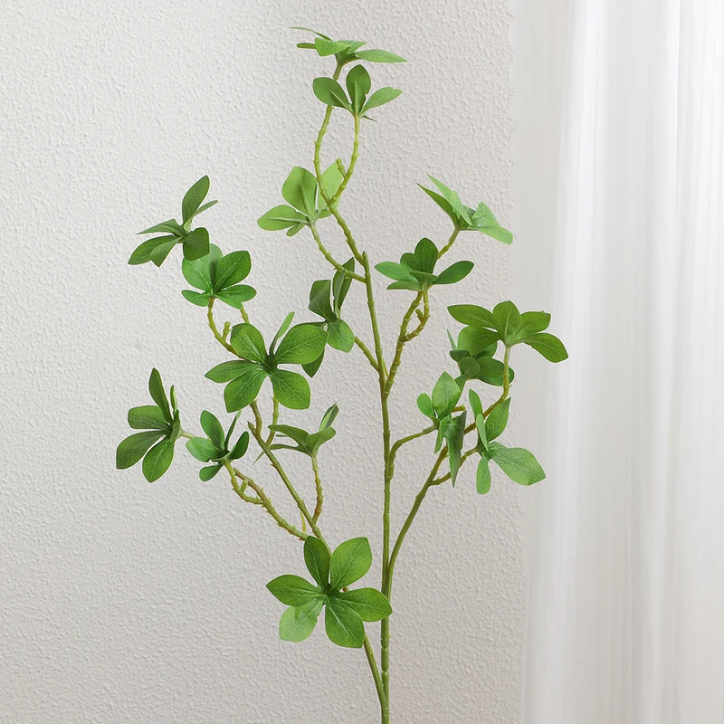 Decorative artificial branch with vibrant leaves
