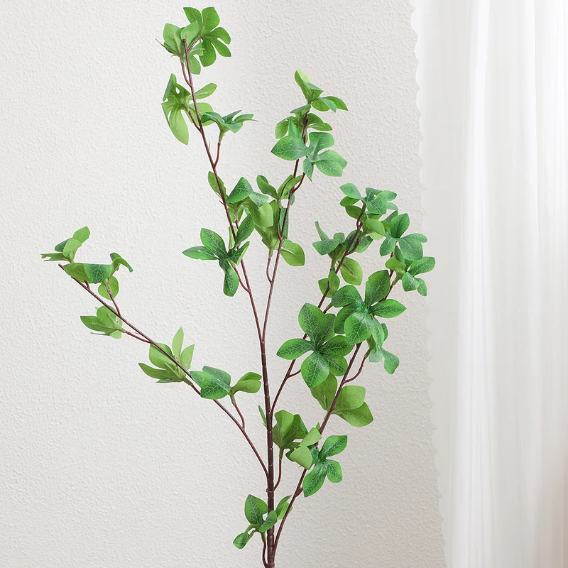 Decorative artificial branch with vibrant leaves