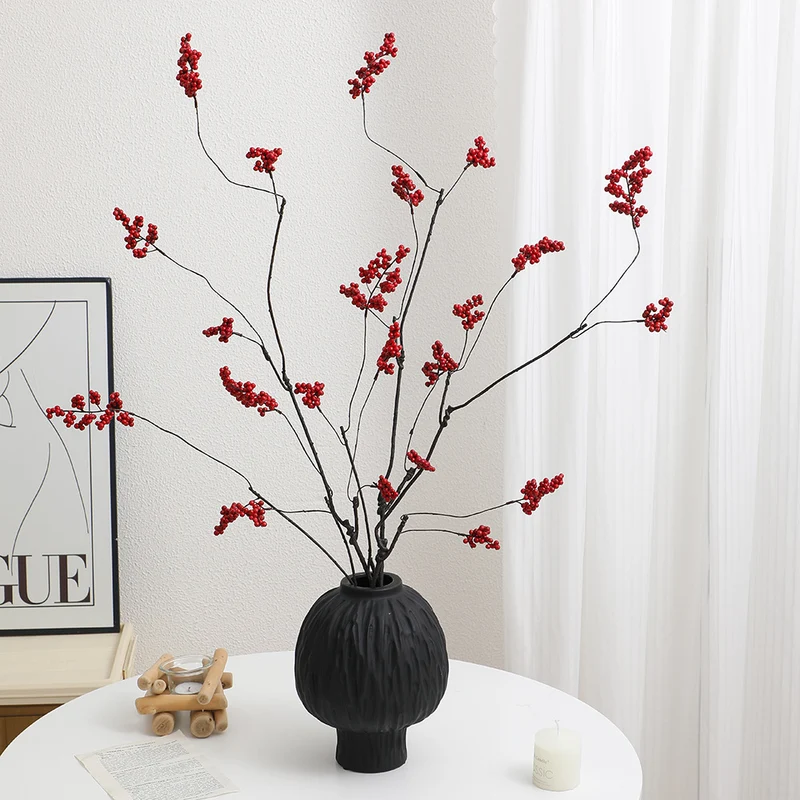 Decorative artificial flower branch with glowing red berries