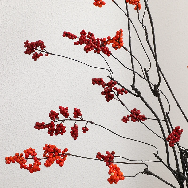 Decorative artificial flower branch with glowing red berries