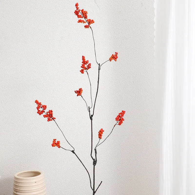 Decorative artificial flower branch with glowing red berries