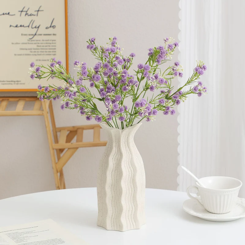 Decorative artificial flower branch with delicate purple flowers
