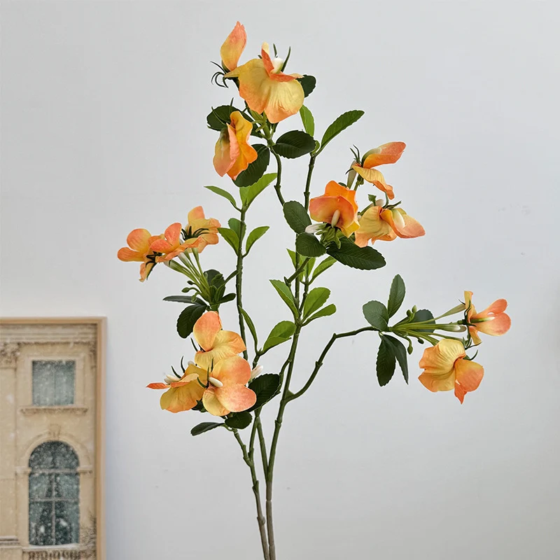Artificial flower branch with vibrant pink flowers