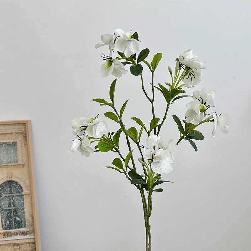 Artificial flower branch with vibrant pink flowers