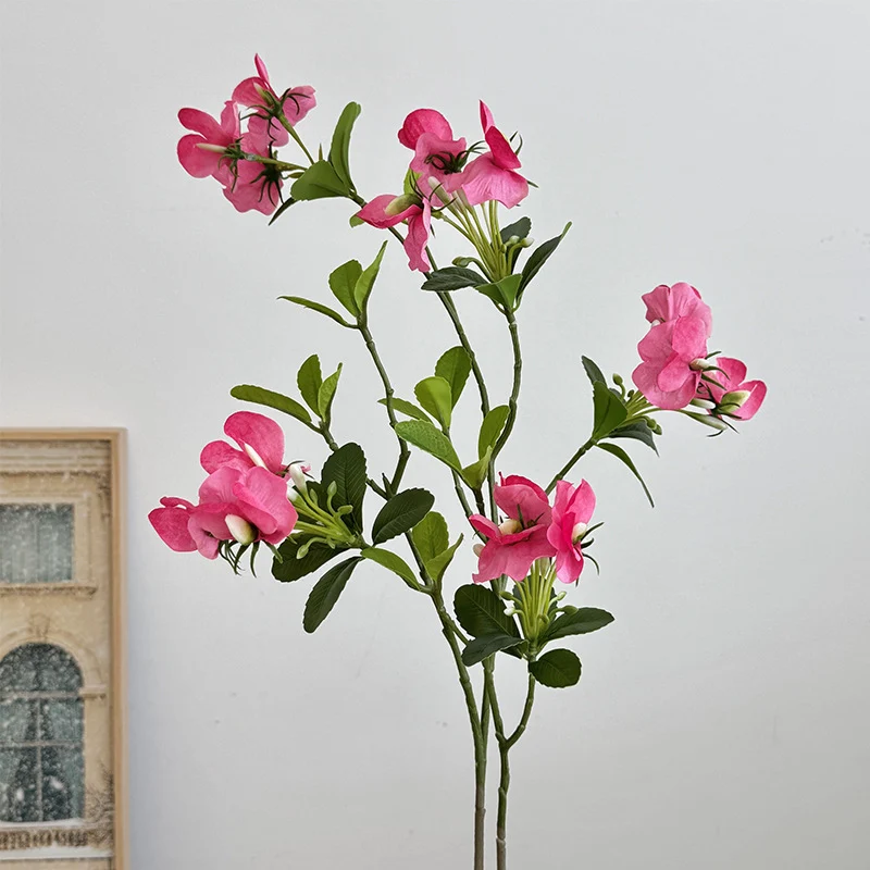 Artificial flower branch with vibrant pink flowers