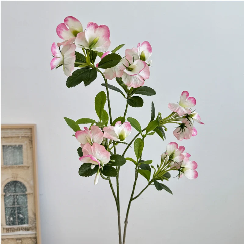 Artificial flower branch with vibrant pink flowers