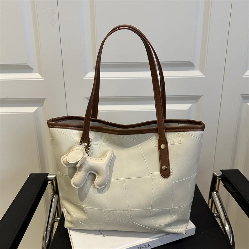 Stylish Textured Tote Bag with Decorative Charm