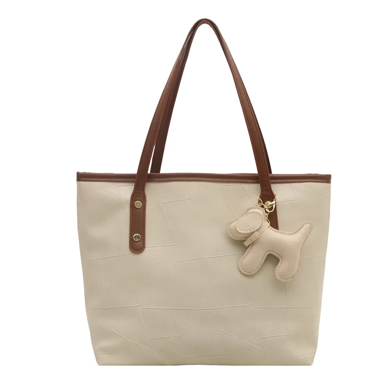 Stylish Textured Tote Bag with Decorative Charm