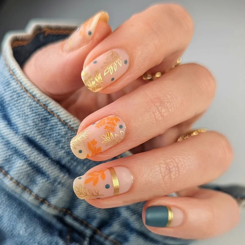 Artistic nail design with floral and golden accent Stornfield