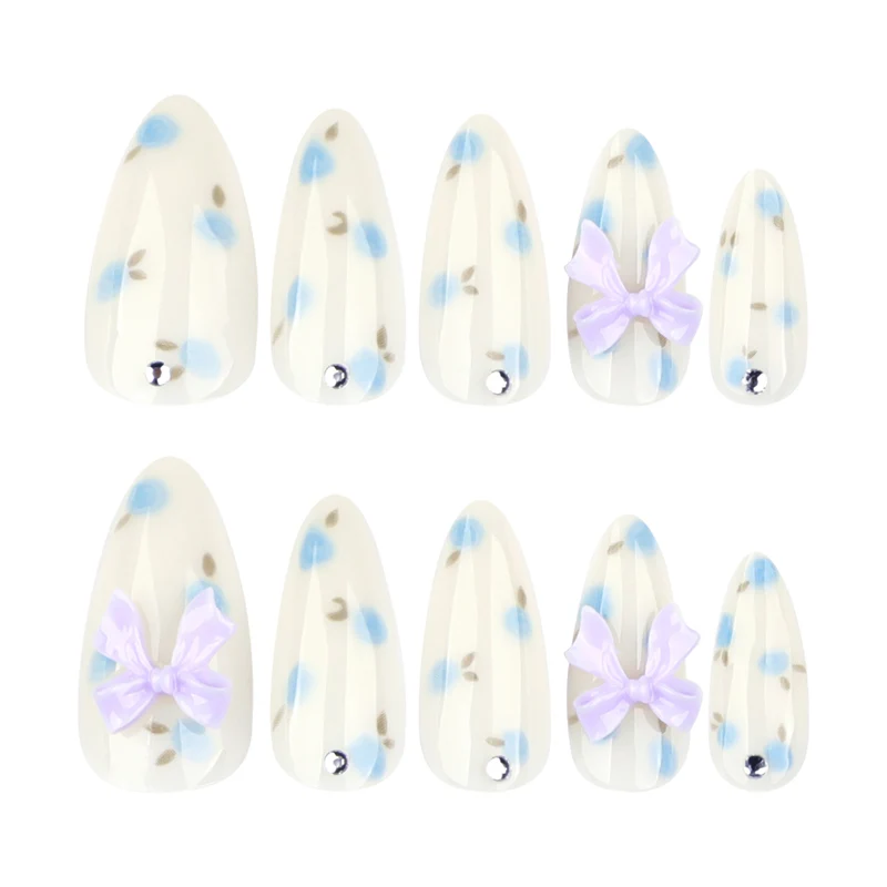 Artful stiletto nails with delicate flower patterns and glitter accents Stornfield