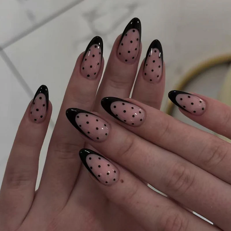 Artistic stiletto nails with black dot pattern Stornfield