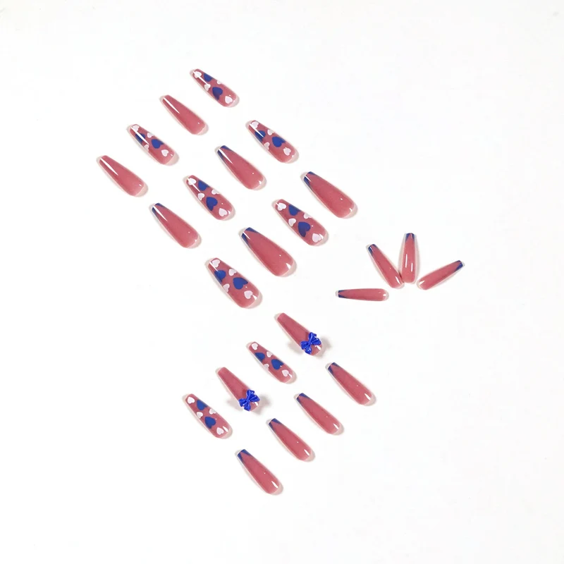 Artful stiletto nails with modern heart and bow motifs Stornfield