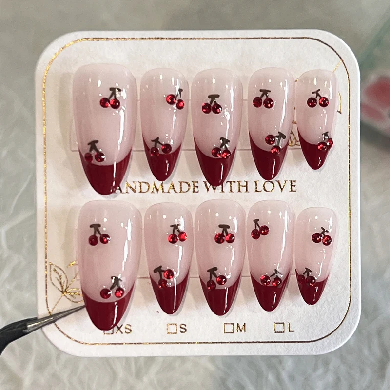 Artful stiletto nails with cherry motifs and glitter accents Stornfield