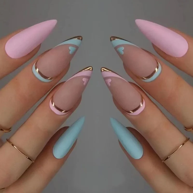 Artistic stiletto nails with gold accents and heart design Stornfield