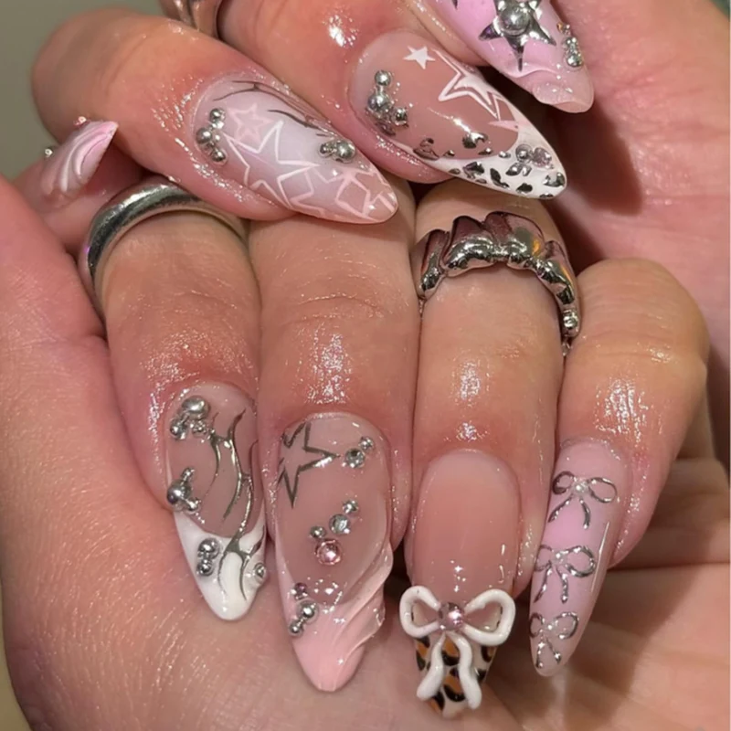 Artful stiletto nails with glitter and bow decorations Stornfield