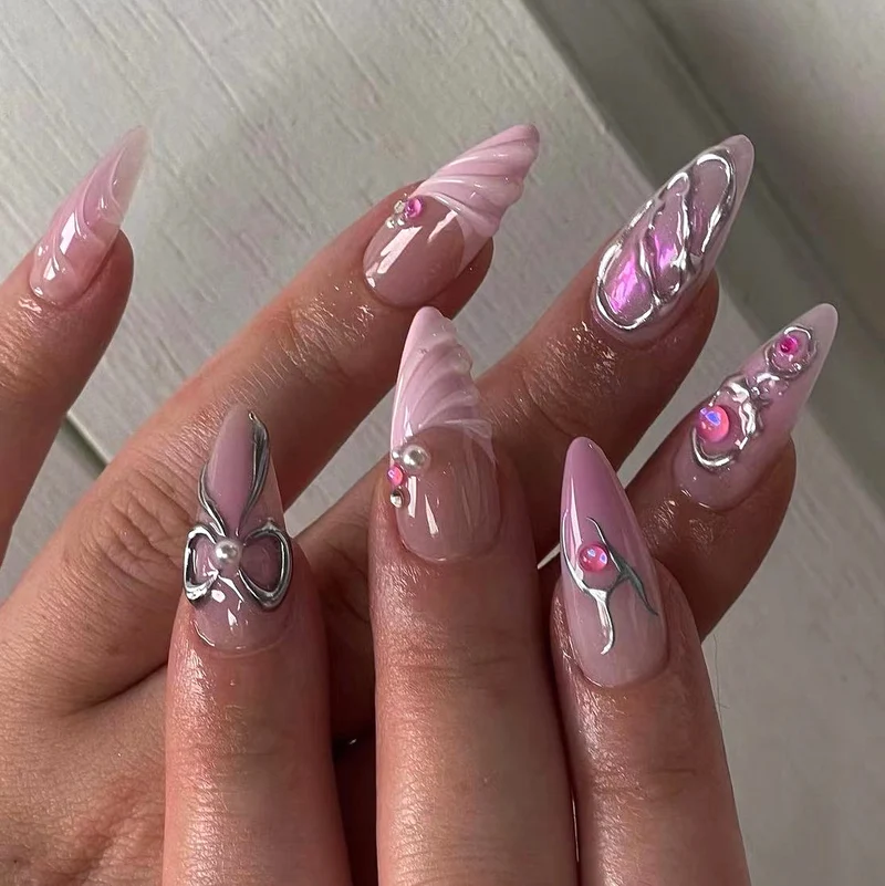Artful stiletto nails with glitter and pearl decorations Stornfield