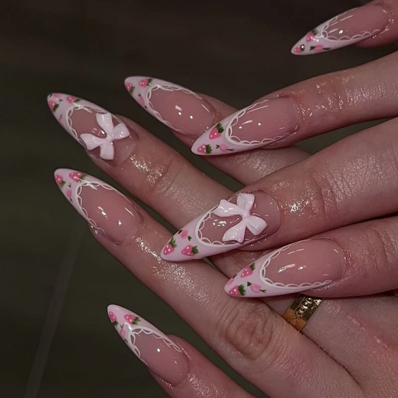Artful stiletto nails with floral accents and bow embellishments Stornfield