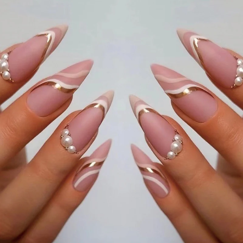 Artful stiletto nails with elegant gold and white accents Stornfield