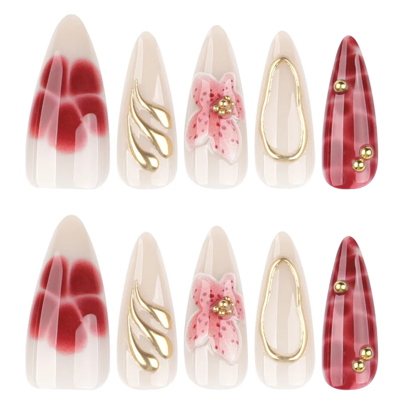 Artful stiletto nails with elegant floral designs and glitter accents Stornfield