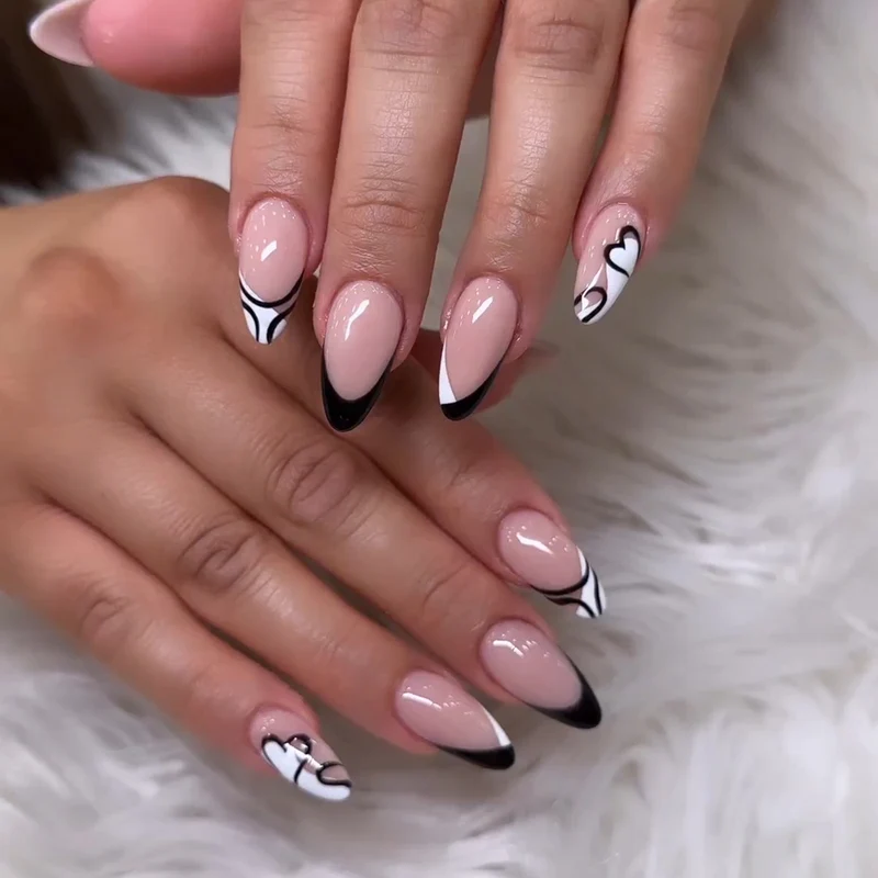 Artful stiletto nails with elegant black-and-white design Stornfield
