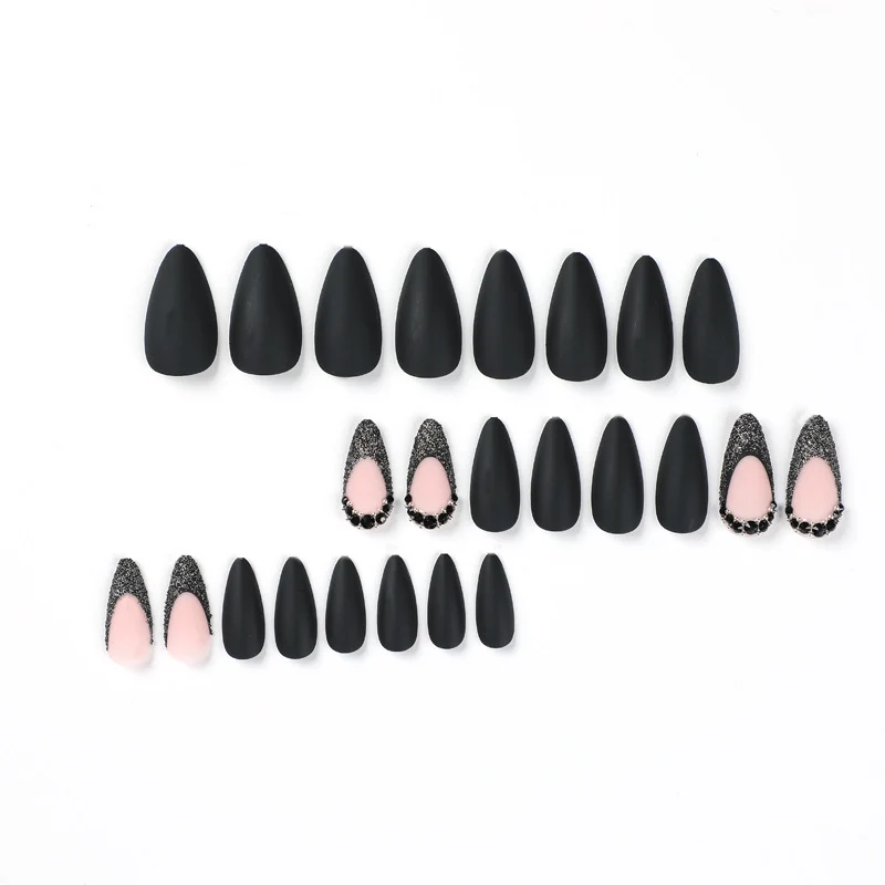 Artful stiletto nails with elegant black design and glitter accents Stornfield