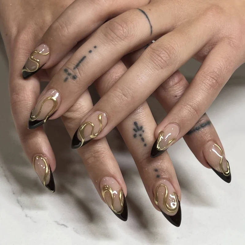 Artful stiletto nails with elegant gold design Stornfield