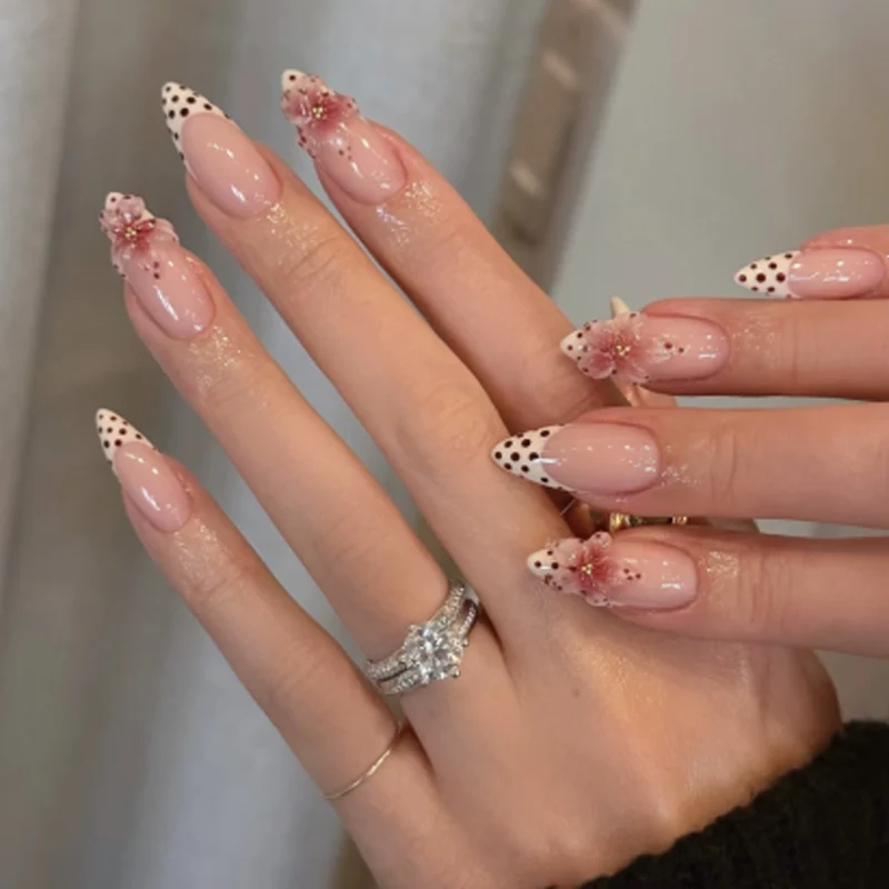 Artful stiletto nails with elegant floral design and glitter details Stornfield